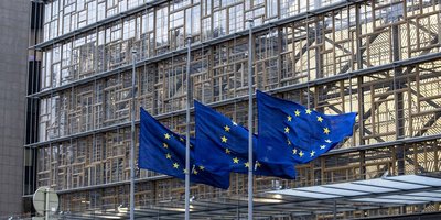 EU flags flying outside the Commission building.