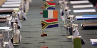 Mini flags of Ireland and South Africa sit on a long table.