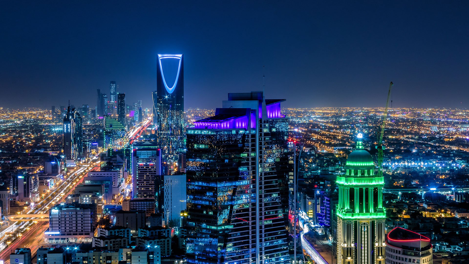 View of the skyling of Riyadh lit up at night time.