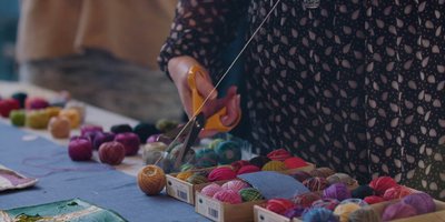 close up of a woman's hands cutting thread