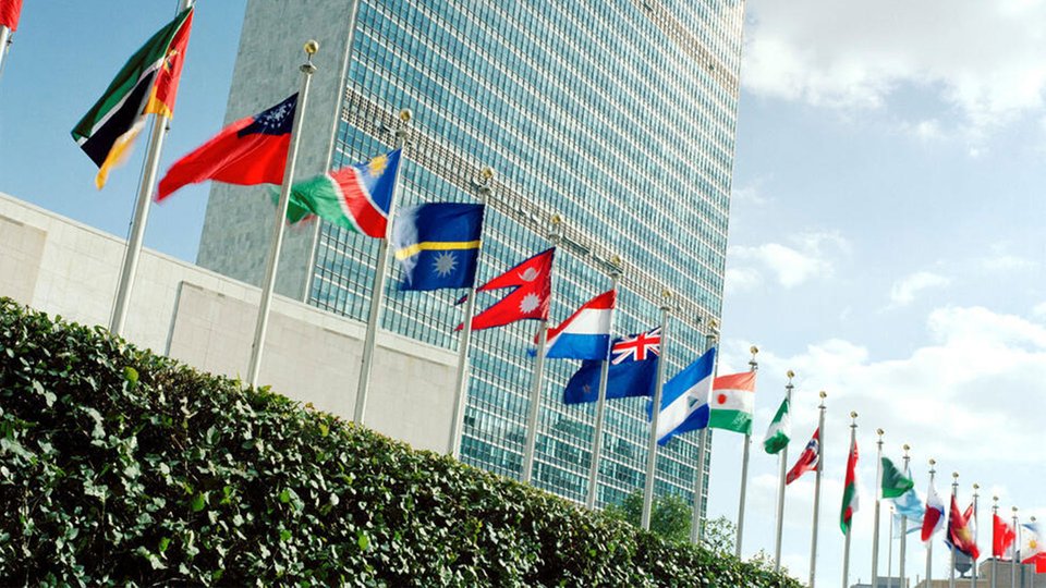 flags in front of large office blocks